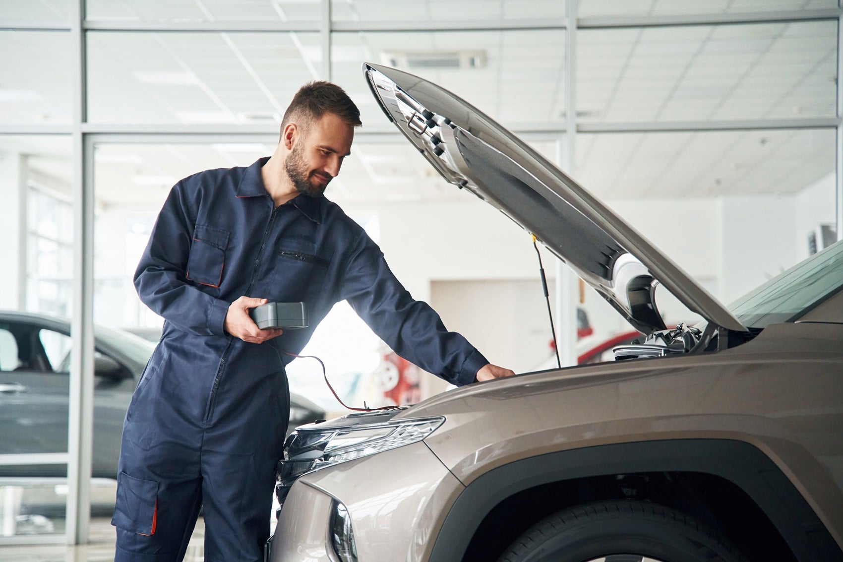 Ford Certified Technician doing maintenance on vehicle at Ford Service Center